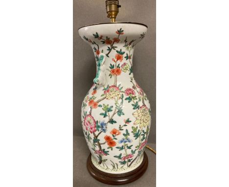 A floral ceramic table lamp on wooden base 