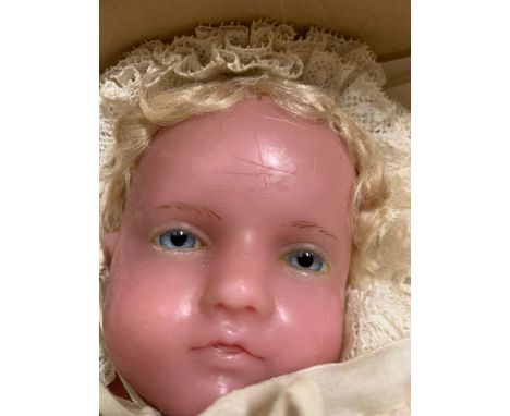 A vintage wax head doll