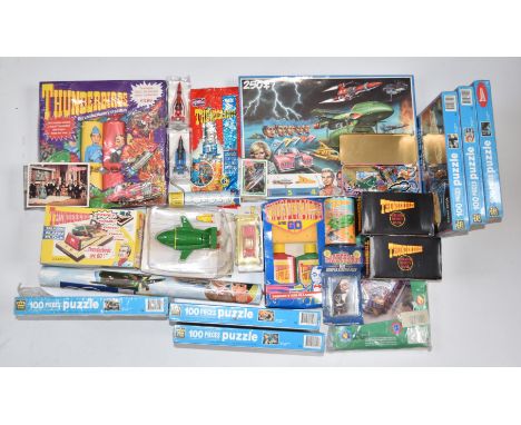 A collection of Thunderbirds related items including puzzles, alarm clock, crackers etc, most in original boxes.&nbsp;