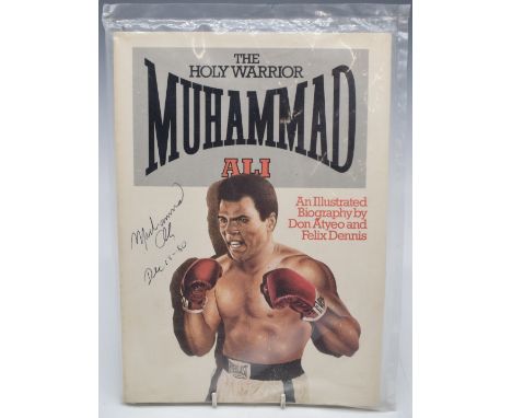 Muhammad Ali signed illustrated biography 'The Holy Warrior Muhammad Ali', signed and dated Dec 18 80 to left hand side, seal