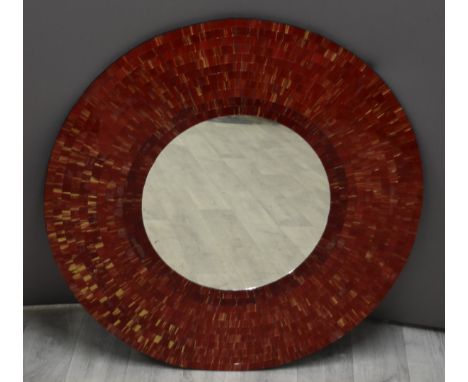 A circular designer mirror with mosaic surround, diameter 80cm
