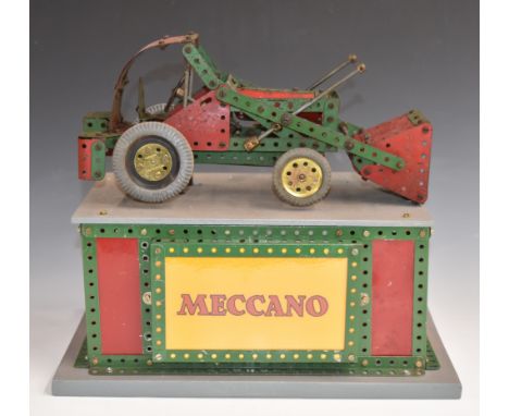 Meccano motorised shop display digger or low loader tractor, raised on illuminated base, 38 x 25.5 x 32cm.