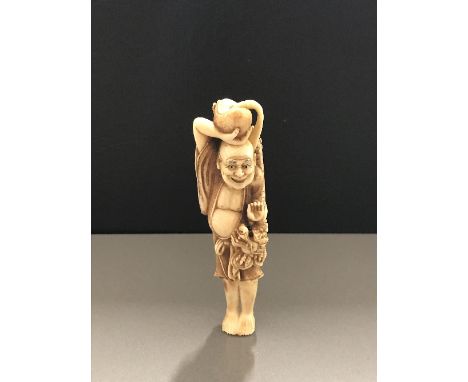 SUPERB QUALITY SIGNED JAPANESE IVROY NETSUKE, a sashi sized study of Amario the keeper of the rain dragon, standing holding a