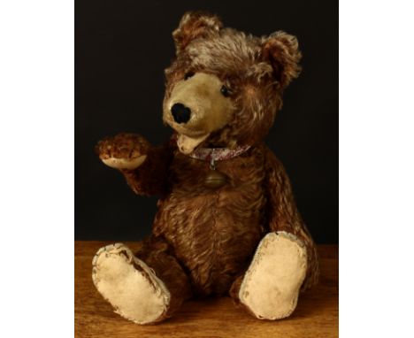 A 1930's/1940's brown mohair jointed Zotty type teddy bear, amber and black glass eyes, pronounced snout with vertically blac