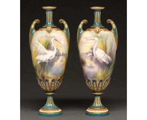 A pair of Hadley's Worcester vases, 1902-1905, painted with egrets in a watery landscape with yellow irises, between coloured