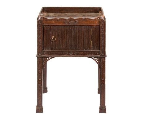 A carved mahogany tray top commode, early 20th c, with mock tambour shutter-door, 75cm h; 43 x 49cm  Top scratched and worn