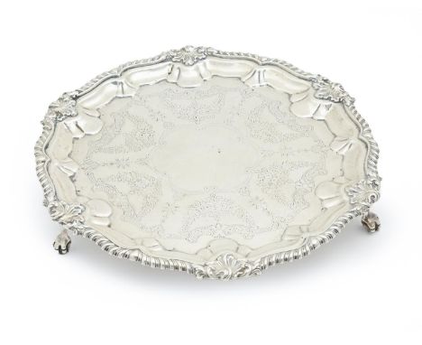 An Edwardian silver salver, engraved with festoons, in gadrooned rim, on claw and ball feet, 30cm diam, by Josiah Williams &a