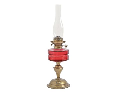 An Art Nouveau brass oil lamp, with faceted cranberry glass fount and Hinks's patent duplex burner, 36cm h excluding chimney 