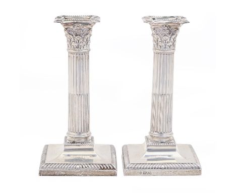 A pair of Edwardian silver column candlesticks, with gadrooned foot, nozzles, 21cm h, by Josiah Williams &amp; Co, London 190
