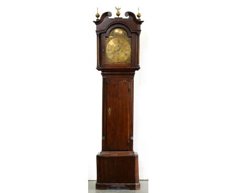 A George III eight day oak longcase clock, South Wales, M Thomas Carnarvon, with breakarched, engraved dial and rococo spandr