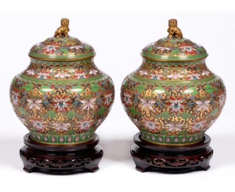A pair of Chinese cloisonne enamel and gilt brass jars and covers, 20th c, in a predominantly apple green and famille rose pa