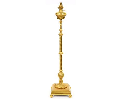 An Edwardian telescopic brass standard oil lamp, with spirally reeded shaft, on square base and ball feet, 142cm h, adapted f