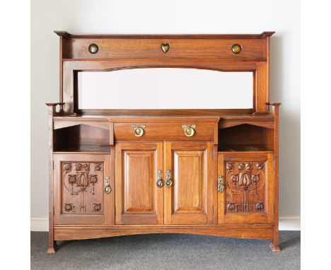 An Arts and Crafts walnut sideboard, by Shapland &amp; Petter of Barnstaple, inset with three enamel roundels and heart to th