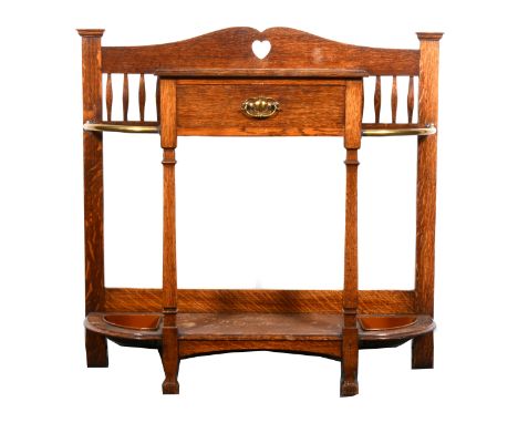 An Arts and Crafts oak hall stand, by Morley &amp; Sons of Leicester, with pierced heart motif above a central drawer, above 