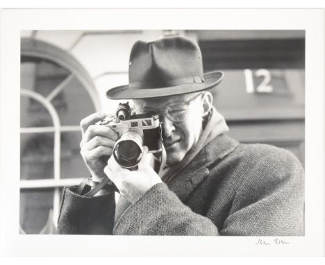 Jane Bown, Henri Cartier-Bresson with Leica M3 , Paris, 1957, silver print, laid on board, printed later, signed in black ink