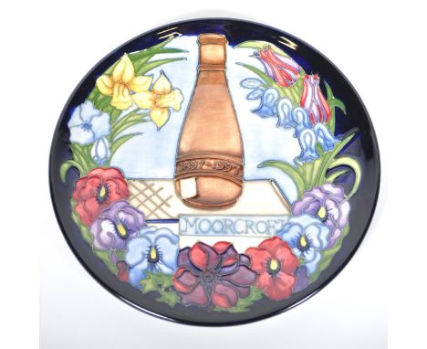 Three Moorcroft Pottery plates, including 'Birth of Light' designed by Nicola Slaney, numbered 500/2000, the Centennial year 
