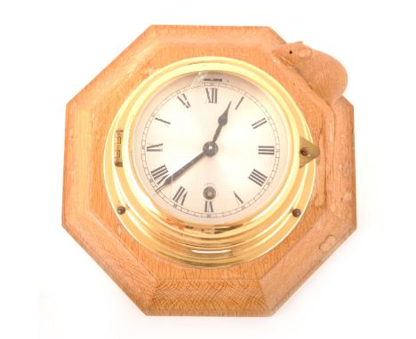 Robert 'Mouseman' Thompson of Kilburn, a carved oak wall clock, with octagonal wooden backplate mounded with a circular brass