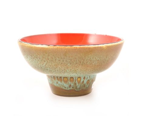 A 'Delphis' ware footed bowl by Poole Pottery, the interior with stylised flowerhead against a vibrant red ground, the exteri
