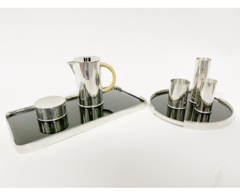 A circular smoked glass and pewter tray, designed by Gerald Benney for Selangor, diameter 26cm, and a similar rectangular tra