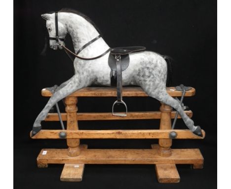 AN EARLY 20TH CENTURY 'SAFETY' ROCKING HORSE, with restored dapple grey paint-work, black leather saddle, brown mane and tail