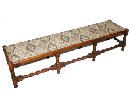 An early 20th century oblong oak foot stool with fabric upholstered top, raised on baluster shaped legs and rope twist suppor