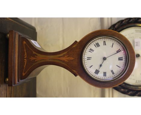 An Art Nouveau mahogany and inlaid mantle clock with wasted form with circular dial, Roman numerals with stylized multicolour