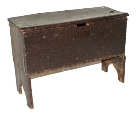 An 18th century oak trunk with lift up lid of plain form, raised on trestle supports, 50H x 72W x 30cmD  Provenance: Original