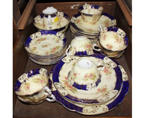 A 19th century tea service, to include cups, saucers, plates, etc, with blue rims and multicoloured floral depictions