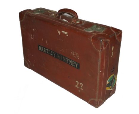 An early 20th century leather travelling trunk or suitcase with lined and fitted interior with metal fittings, 67cm wide