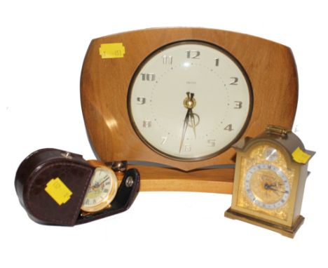 A Swiza Tempus Fugit eight-day miniature brass mantle / bedside alarm clock and a Roger Lascelles circular brass travel clock