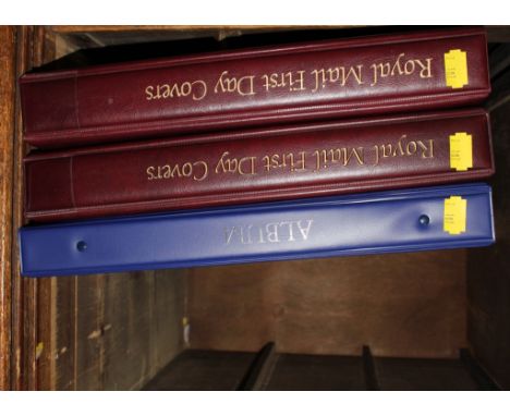An assortment of Royal Mail First Day Covers in three bound albums