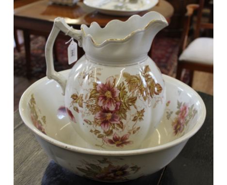 A Victorian-style ceramic ewer and bowl with floral and foliate depictions