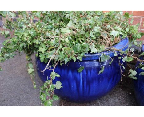 A large blue glazed circular planter