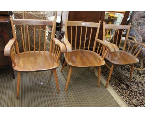Three Ercol style stick back armchairs with solid seats