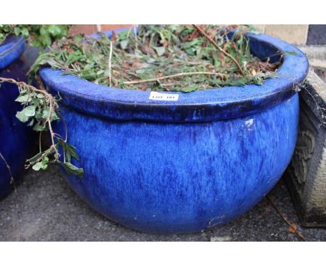A large blue glazed circular planter