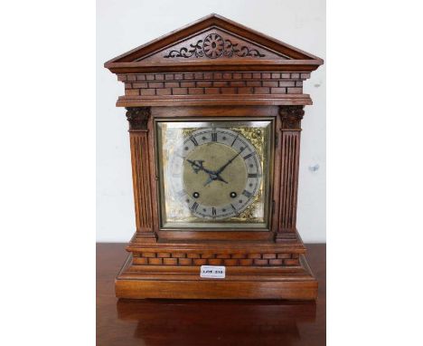 An early 20th century probably German mahogany cased clock with chiming movement pendulum and key