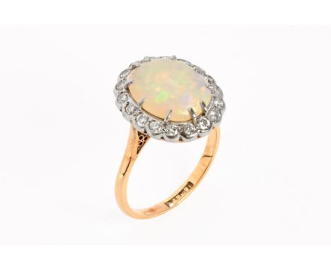 An 18 ct gold opal and diamond ring.  Size Q, opal +/- 14 mm x 11 mm (see illustration).