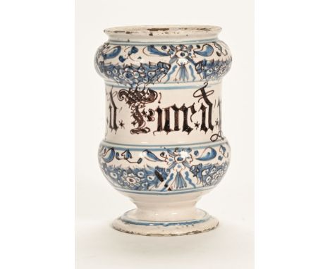 An early 19th century Delftware apothecary jar, blue and white floral decorated and inscribed. 18.5 cm high (see illustration