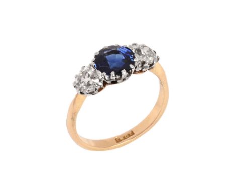 An 18 ct gold diamond and sapphire ring, central sapphire +/- 1 carat, flanked by two diamonds each +/- .3 carat.  Size K (se