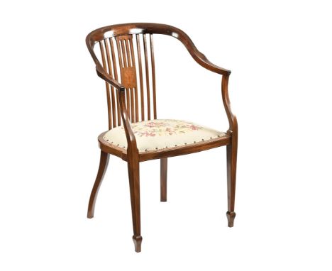 An Edwardian mahogany salon armchair, with inlay and burr decoration with slat back, sweep arms, floral tapestry seat and sle
