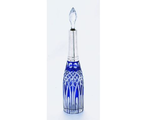 An Edwardian blue glass overlay cut glass spirit flask, with silver coloured metal mount and faceted stopper.  Height 35.5 cm