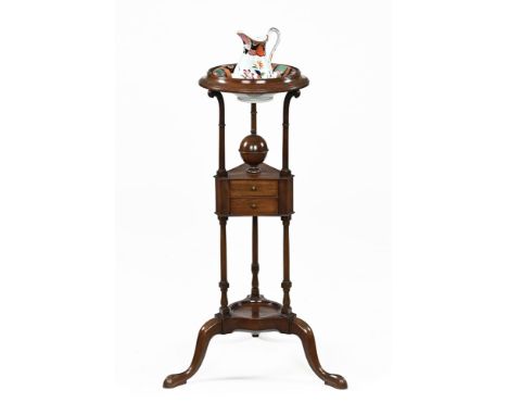 A 20th century Georgian style shaving stand, with circular rim top on trefoil ring supports with triangular double drawer tie