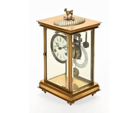 An early 20th century four glass brass mantel clock, with two train movement striking on a coil and white enamel chapter ring