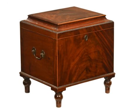 A Regency mahogany cellarette, with caddy top beaded edge opening to interior divisions and all raised on short turned legs. 