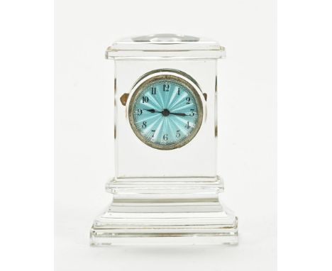 An early 20th century glass cased clock, with timepiece movement and enamelled dial.  Height 9.5 cm, width 6.8 cm.   CONDITIO