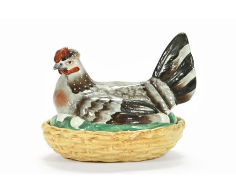A 19th century Staffordshire hen on nest egg cruet, with eggs in sight.  Length 19 cm.   CONDITION REPORT:  Significant chips