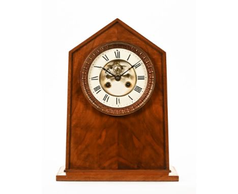 An early 20th century mahogany eight day movement mantel clock, with pointed arched pediment and white enamel dial with Roman