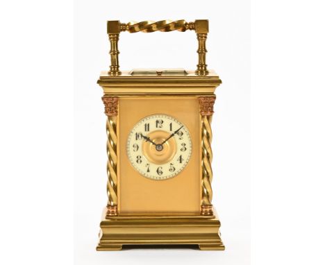 A late 19th century brass carriage clock of French design, with Prince of Wales and wrythen twist handle and columns, contain