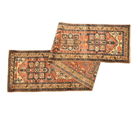 A Persian runner, with red ground and six central medallions bordered by geometric and floral decorated bands.  460 cm long, 
