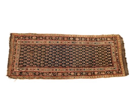 An Eastern hand woven carpet runner, of blue and yellow ground in Kazak style.  284 x 113 cm.